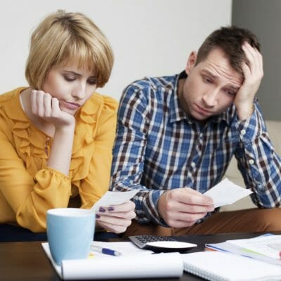 frustrated couple with bills